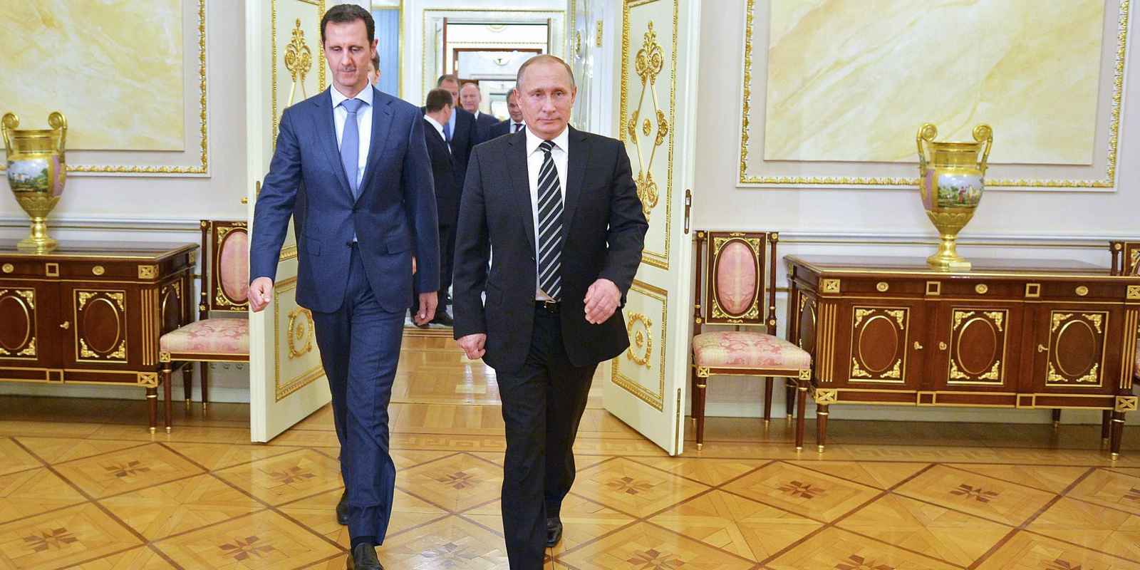 Russian President Vladimir Putin (R) greets his Syrian counterpart Bashar al-Assad upon his arrival for a meeting at the Kremlin in Moscow on October 21, 2015. Assad, on his first foreign visit since Syria's war broke out, told his main backer and counterpart Putin in Moscow that Russia's campaign in Syria has helped contain "terrorism". AFP PHOTO / RIA NOVOSTI / KREMLIN POOL / ALEXEY DRUZHININ        (Photo credit should read ALEXEY DRUZHININ/AFP/Getty Images)