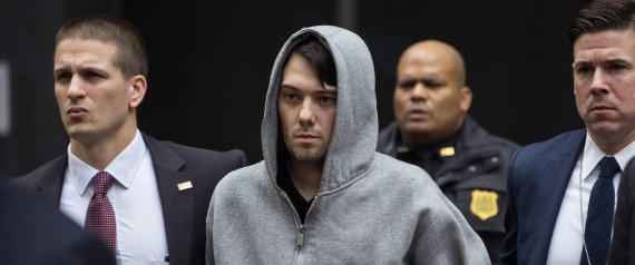 Martin Shkreli, the former hedge fund manager under fire for buying a pharmaceutical company and ratcheting up the price of a life-saving drug, is escorted by law enforcement agents in New York Thursday, Dec. 17, 2015, after being taken into custody following a securities probe. A seven-count indictment unsealed in Brooklyn federal court Thursday charged Shkreli with conspiracy to commit securities fraud, conspiracy to commit wire fraud and securities fraud. (AP Photo/Craig Ruttle)