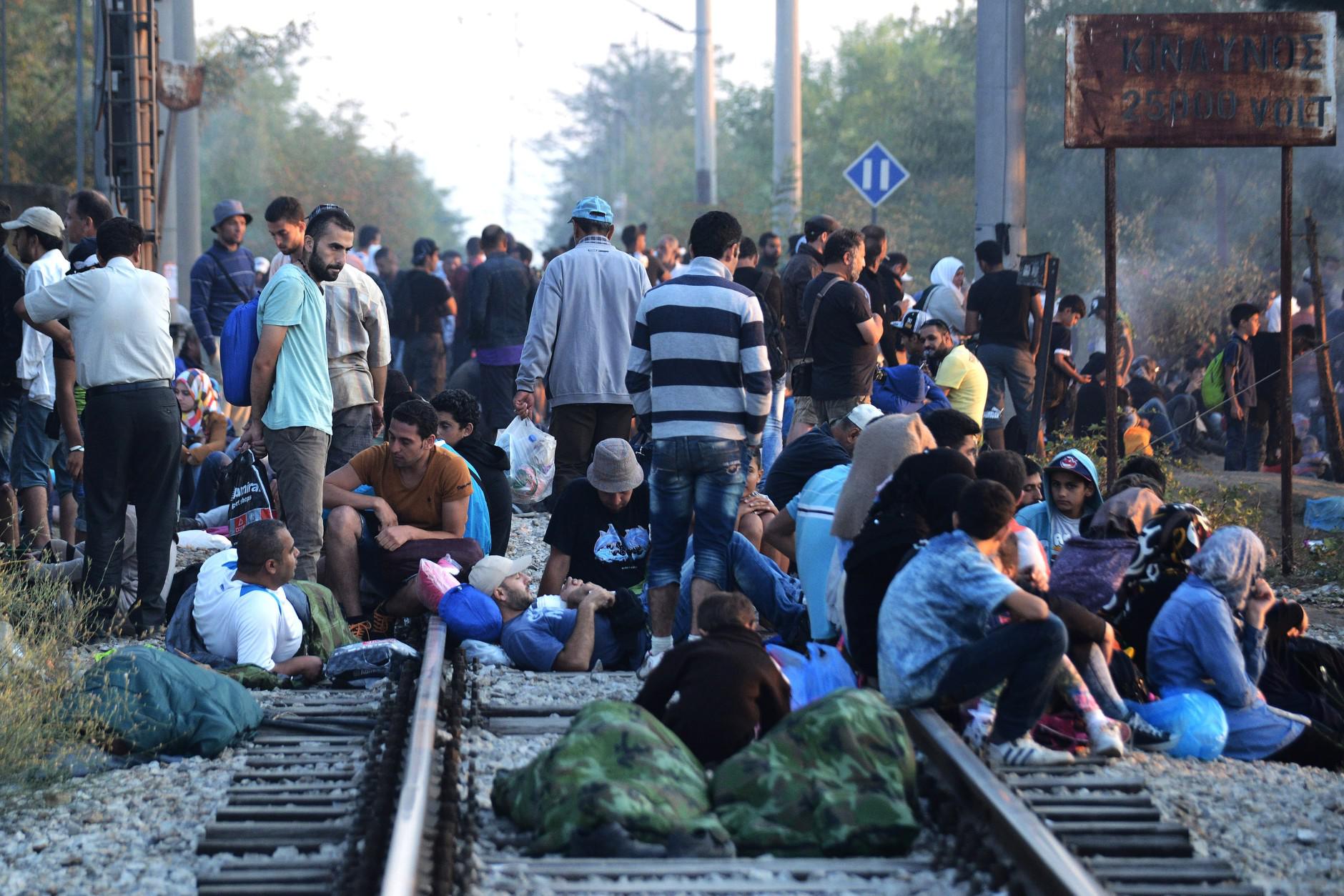 FOR WEDNESDAY AUG. 19, 2015 STORY MIGRANTS LOST IN TRANSIT BY KOSTAS KADOURIS - In this picture made on Wednesday, Aug. 12, 2015, Syrian refugee wait at a railroad track of Idomeni, northern Greece. Bureaucratic mistakes and oversights by Greek officials overwhelmed by an unprecedented refugee influx are making life harder for thousands transiting through Greece as they flee war in Syria, but are caught with Greek transit papers that are faulty because of careless mistakes by overwhelmed officials. (AP Photo/Giannis Papanikos)
