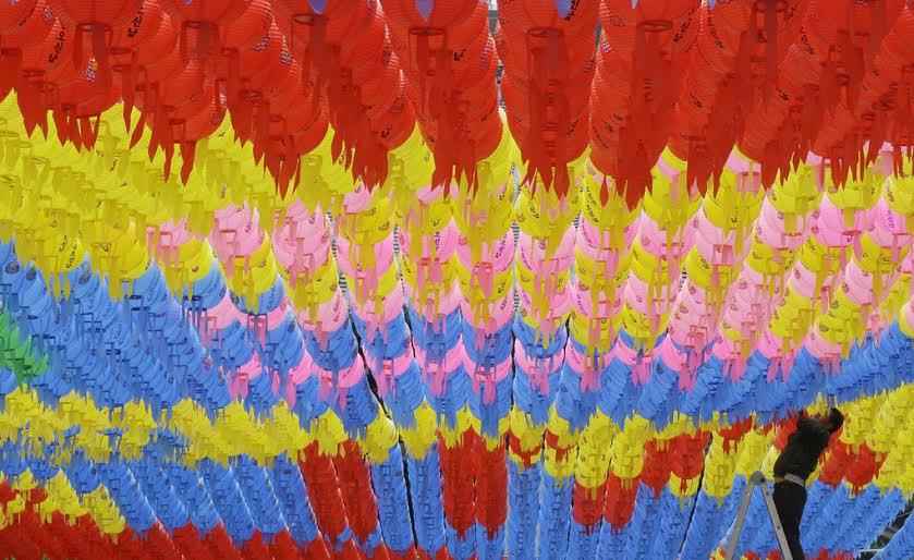 A worker adjusts lanterns for the upcoming celebration of Buddha's birthday on May 14 at the Bongeun temple in Seoul, South Korea, Wednesday, April 27, 2016. Similar lanterns will be displayed in all Buddhist temples around South Korea for the public viewing. (AP Photo/Ahn Young-joon) SEL105 (Ahn Young-joon / The Associated Press)
