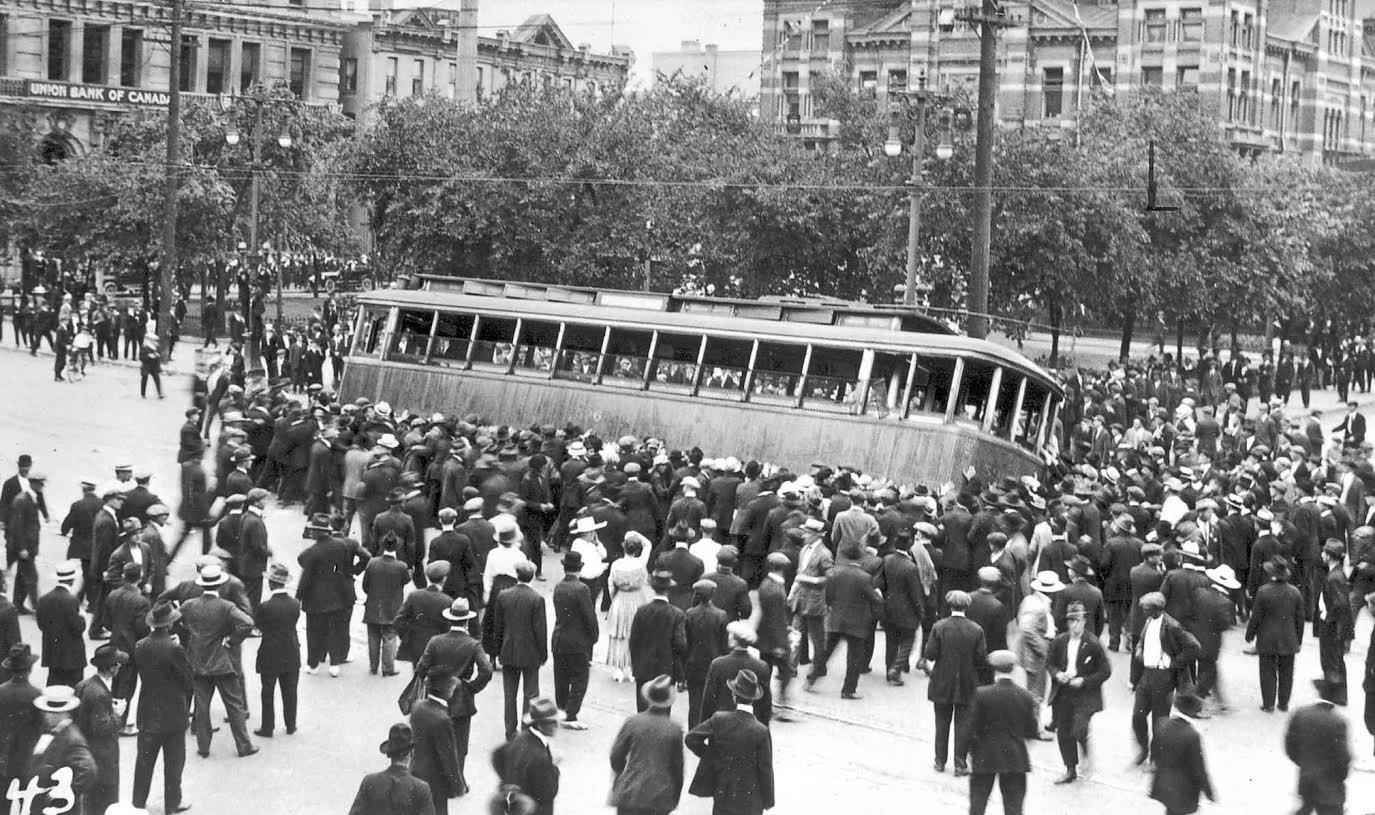 A streetcar is overturned in 1919 in the Winnipeg General Strike in front of the old city hall building on Main Street.