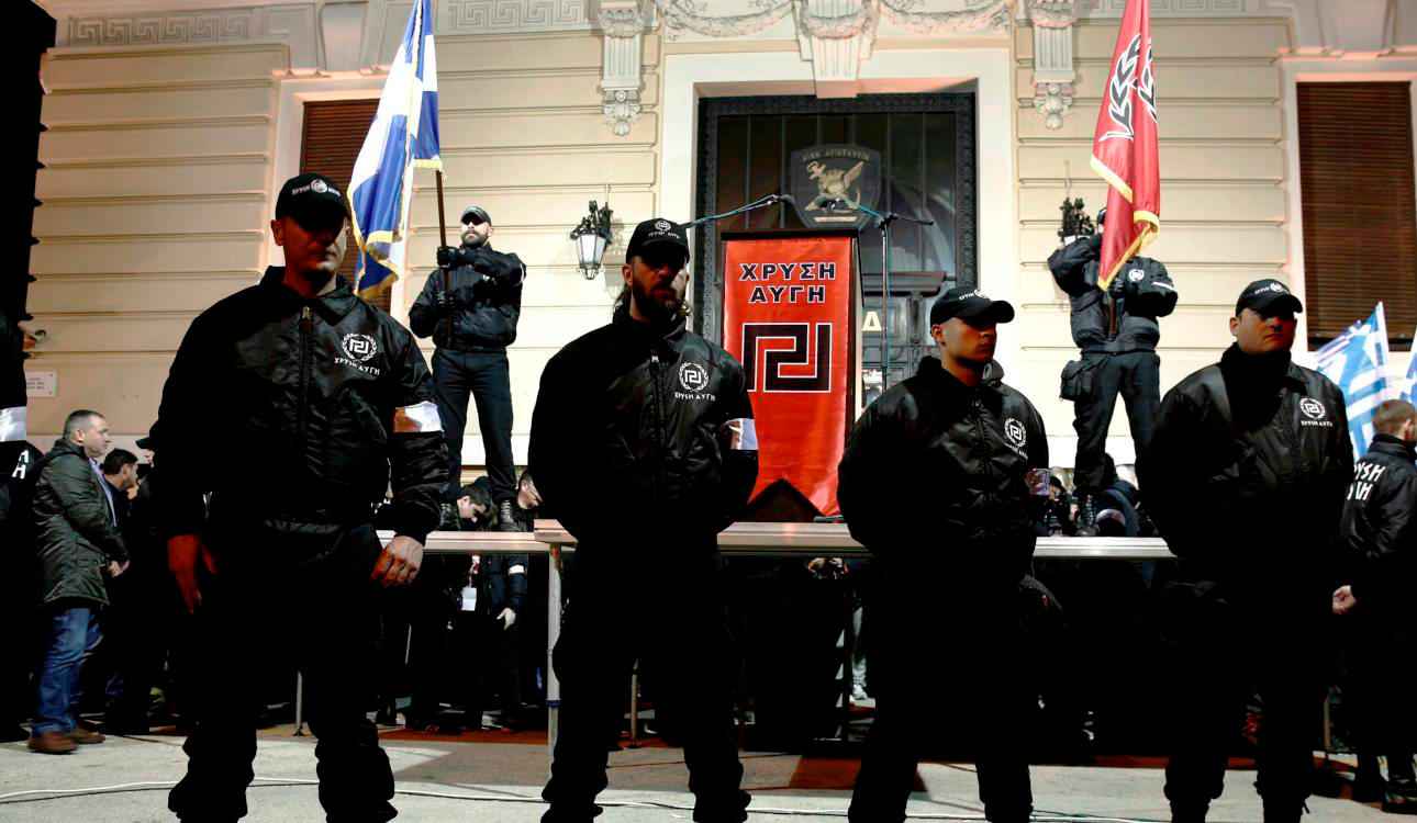 Members of the extreme-right Golden Dawn party stand around a stage during a gathering in Athens February 2, 2013. Thousands of supporters gathered to pay tribute to three Greek officers who were killed when their helicopter crashed during a crisis with Turkey over the eastern Aegean isle of Imia back in 1996. REUTERS/Yorgos Karahalis (GREECE - Tags: POLITICS CIVIL UNREST)