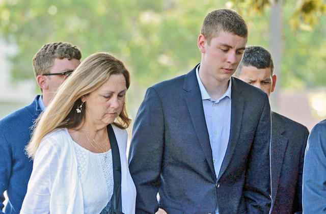 FILE - In this June 2, 2016 file photo, Brock Turner, right, makes his way into the Santa Clara Superior Courthouse in Palo Alto, Calif. The former Stanford University swimmer convicted of sexually assaulting an unconscious woman is poised to leave jail Friday, Sept. 2, 2016, after serving half a six-month sentence that critics denounced as too lenient. (Dan Honda /San Jose Mercury News via AP, File)