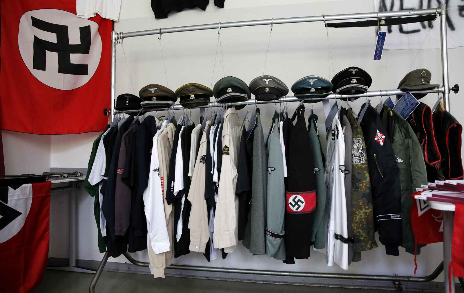 Nazi uniforms and a Swastika flag that were confiscated by the Berlin police during raids against German neo-Nazis are presented to the public during an open day at a police barracks in Berlin, September 7, 2014.  REUTERS/Fabrizio Bensch (GERMANY - Tags: SOCIETY) - RTR459L6